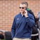 Feb 1, 2022; Mobile, AL, USA; Auburn football head coach Bryan Harsin takes a call while watching National practice for the 2022 Senior Bowl at Hancock Whitney Stadium. Mandatory Credit: Vasha Hunt-USA TODAY Sports